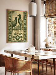 Art Nouveau style wall art print with two dark green stylised birds, leafy bush, decorative panel, in a styled room mockup