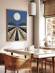 Stylised landscape art print with large white moon, wheat plants, and geometric patterned fields in, in a styled room mockup