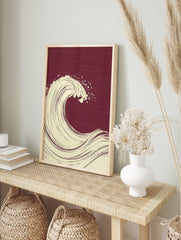 Stylised cream ocean wave illustration with spray on a deep burgundy textured background in, in an alternate framed mockup