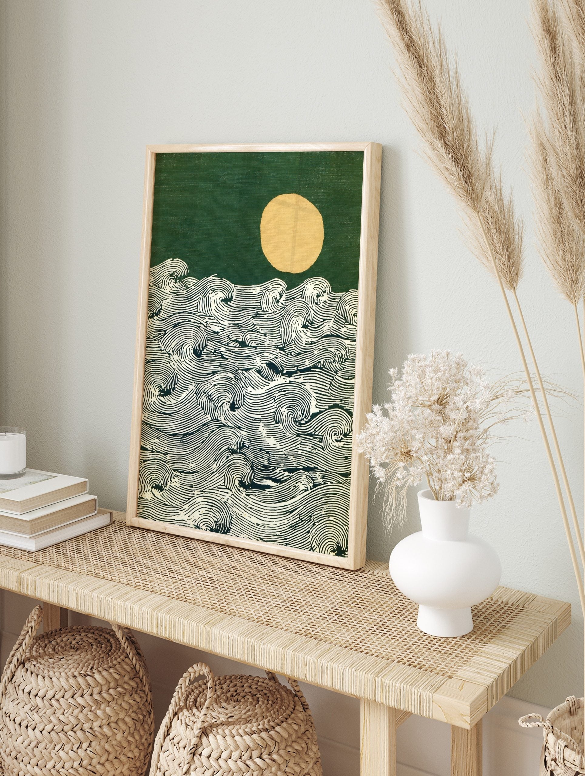 Stylised ocean waves with detailed lines, a pale yellow moon, and a dark green sky art print, in an alternate framed mockup