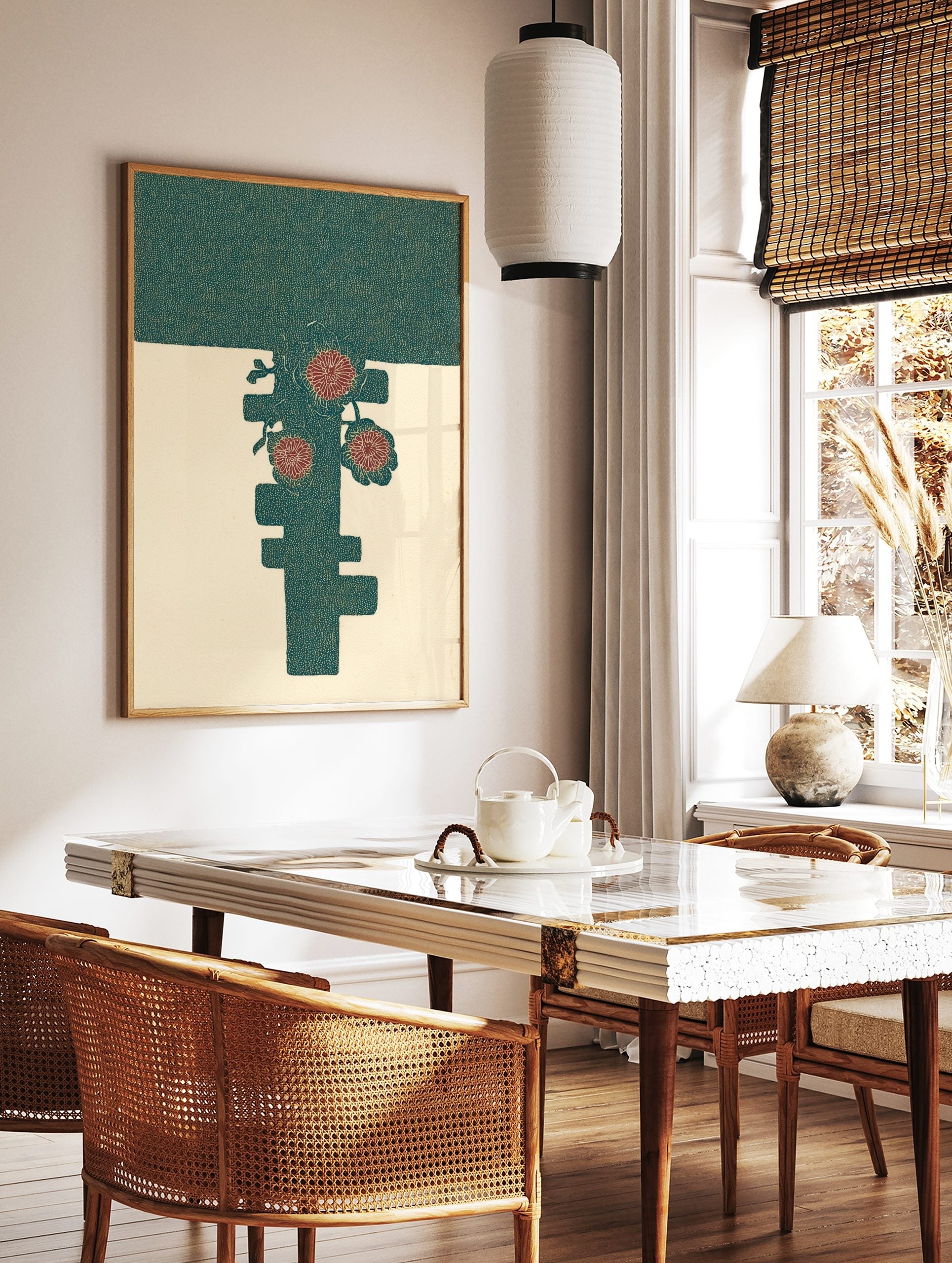 Stylised red flowers and leaves on a dark teal abstract shape against a cream background, in a styled room mockup