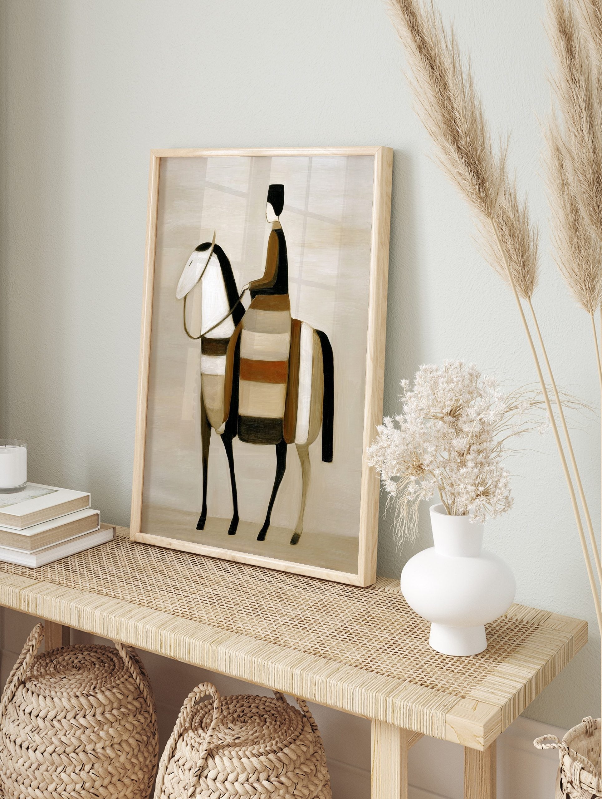 Stylised abstract art print of a rider on a horse in earth tones, black, and white, in an alternate framed mockup