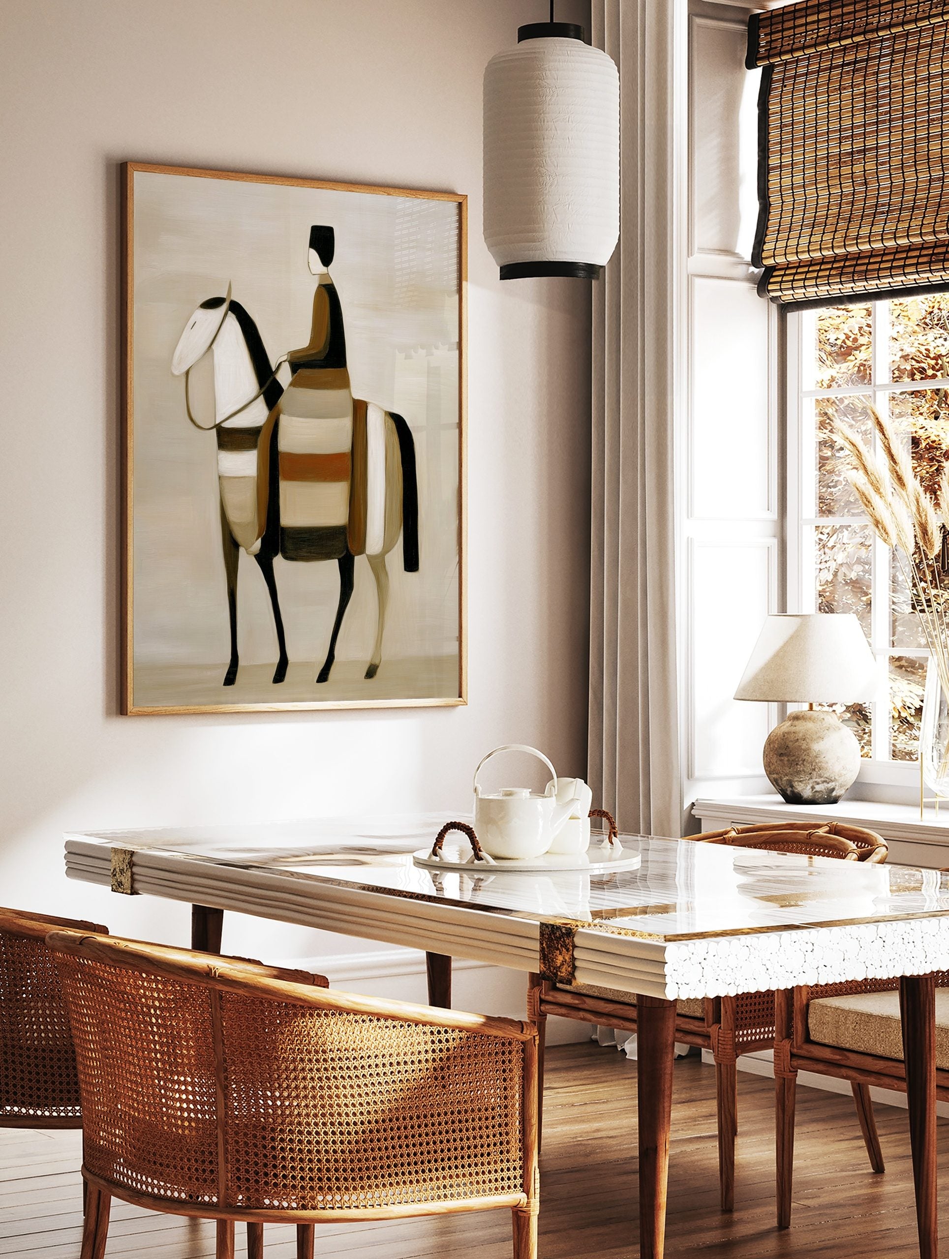 Stylised abstract art print of a rider on a horse in earth tones, black, and white, in a styled room mockup