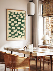 Repeating pattern of stylised cream sheep on a dark green background with a red seal in the corner, in a styled room mockup