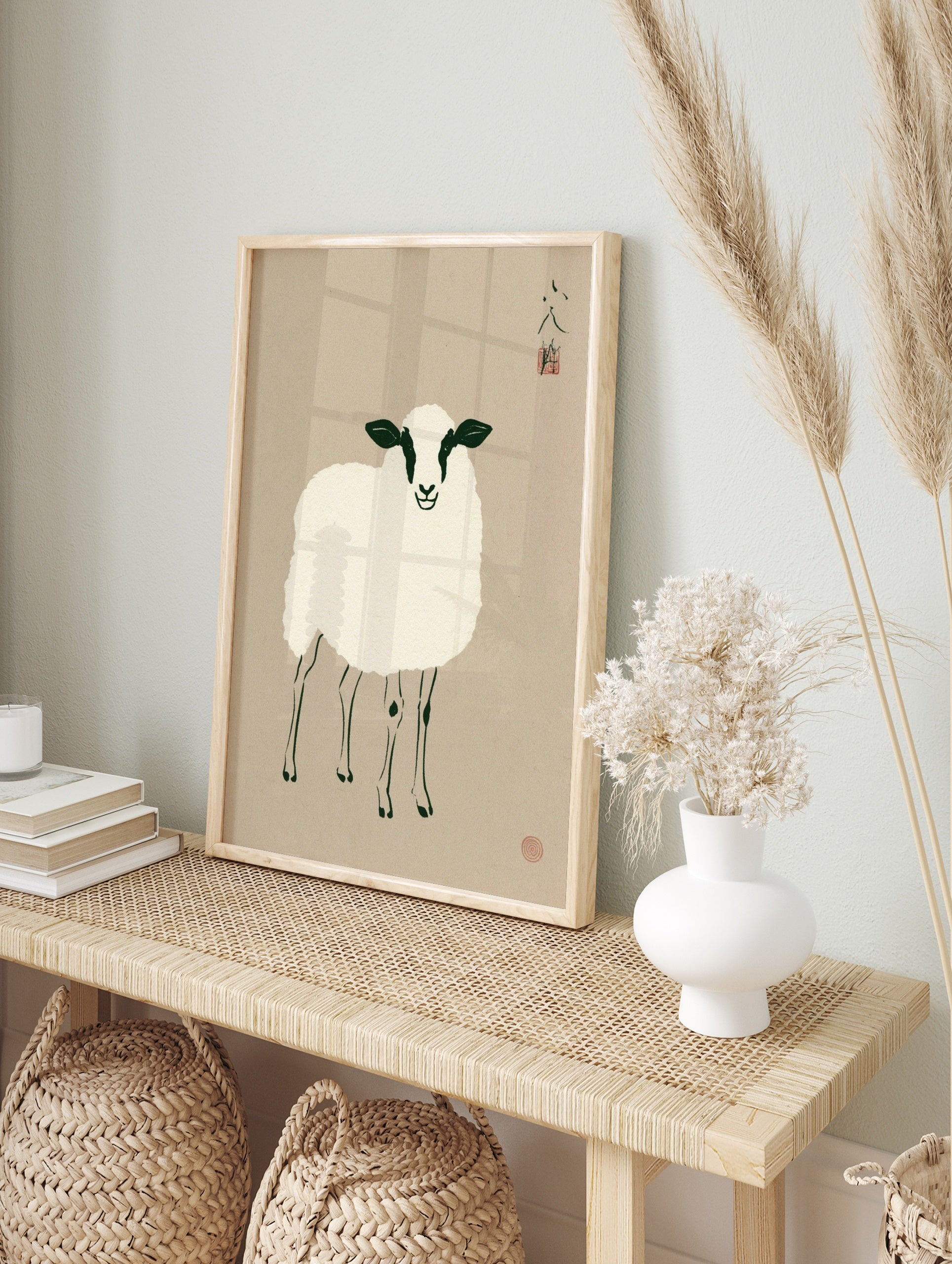 Minimalist illustrative sheep art print with black and white details on a beige background, in an alternate framed mockup