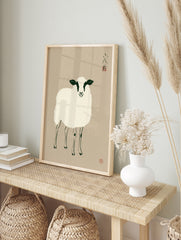 Minimalist illustrative sheep art print with black and white details on a beige background, in an alternate framed mockup