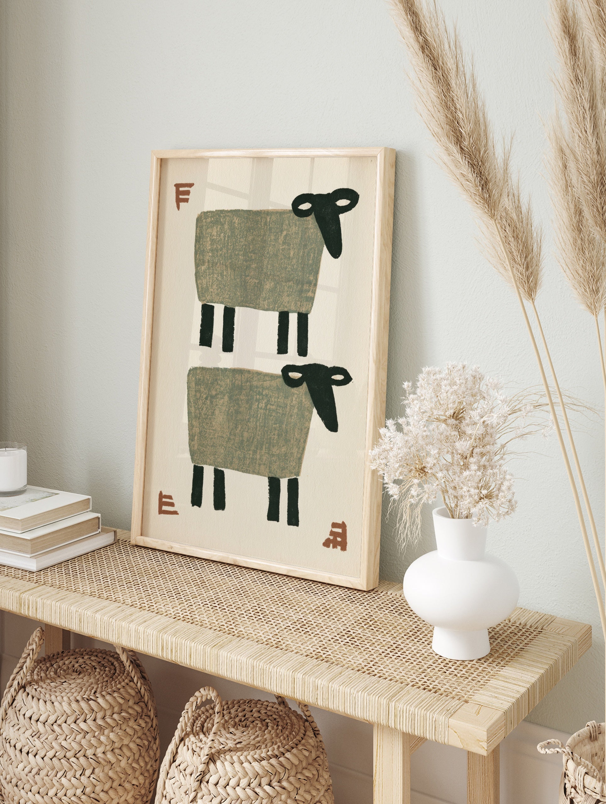 Stylised minimalist sheep wall art with two grey sheep and terracotta typographic accents on, in an alternate framed mockup