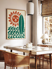Stylised sun with a face, green surfboard, and ocean waves on a cream background art print, in a styled room mockup