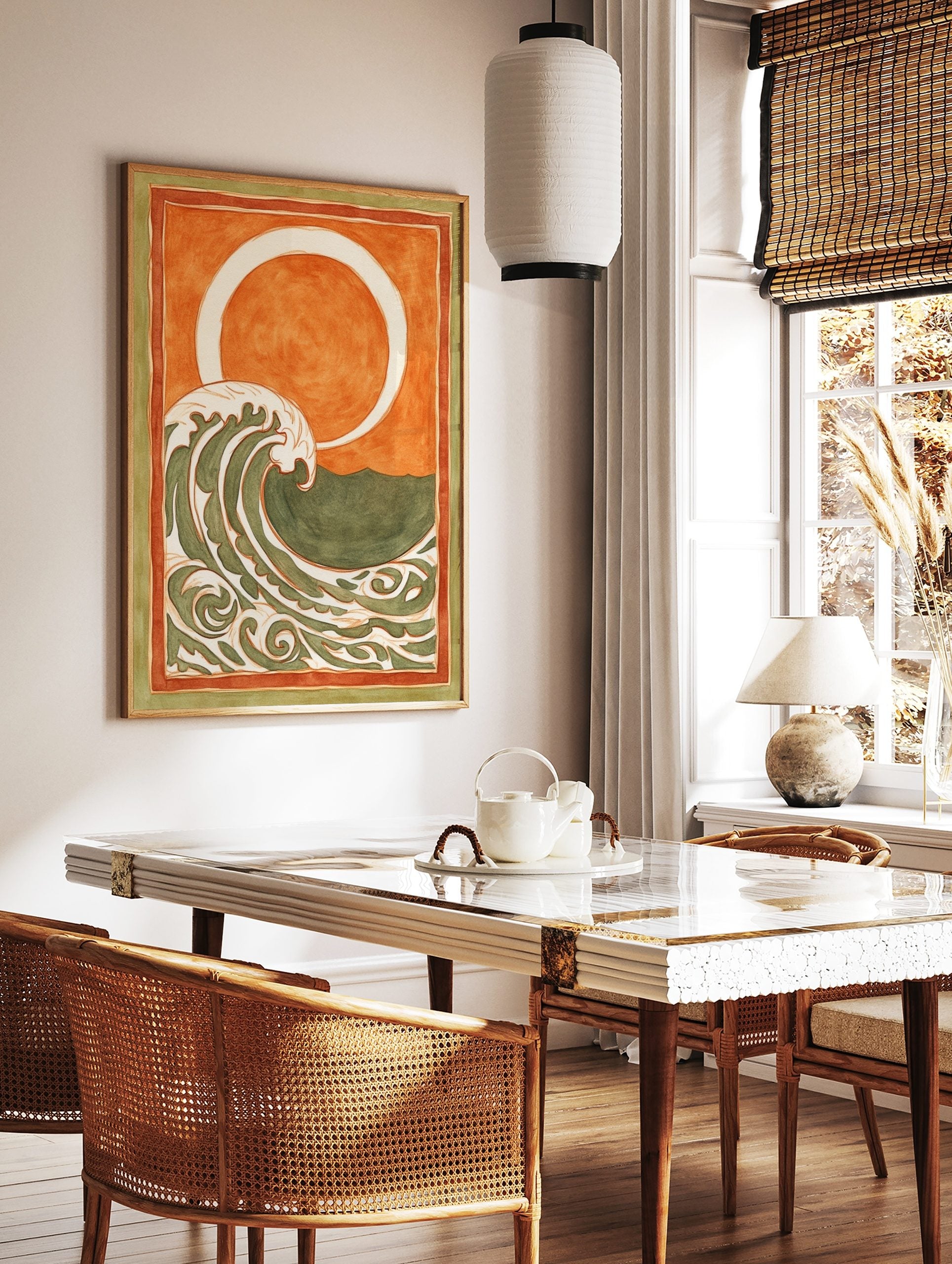 Stylised ocean wave art print with cream and green patterns, orange sky, white sun/moon, and, in a styled room mockup