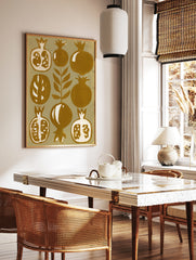 Stylized botanical pomegranate fruit illustration in mustard yellow and cream on paper wall art, in a styled room mockup