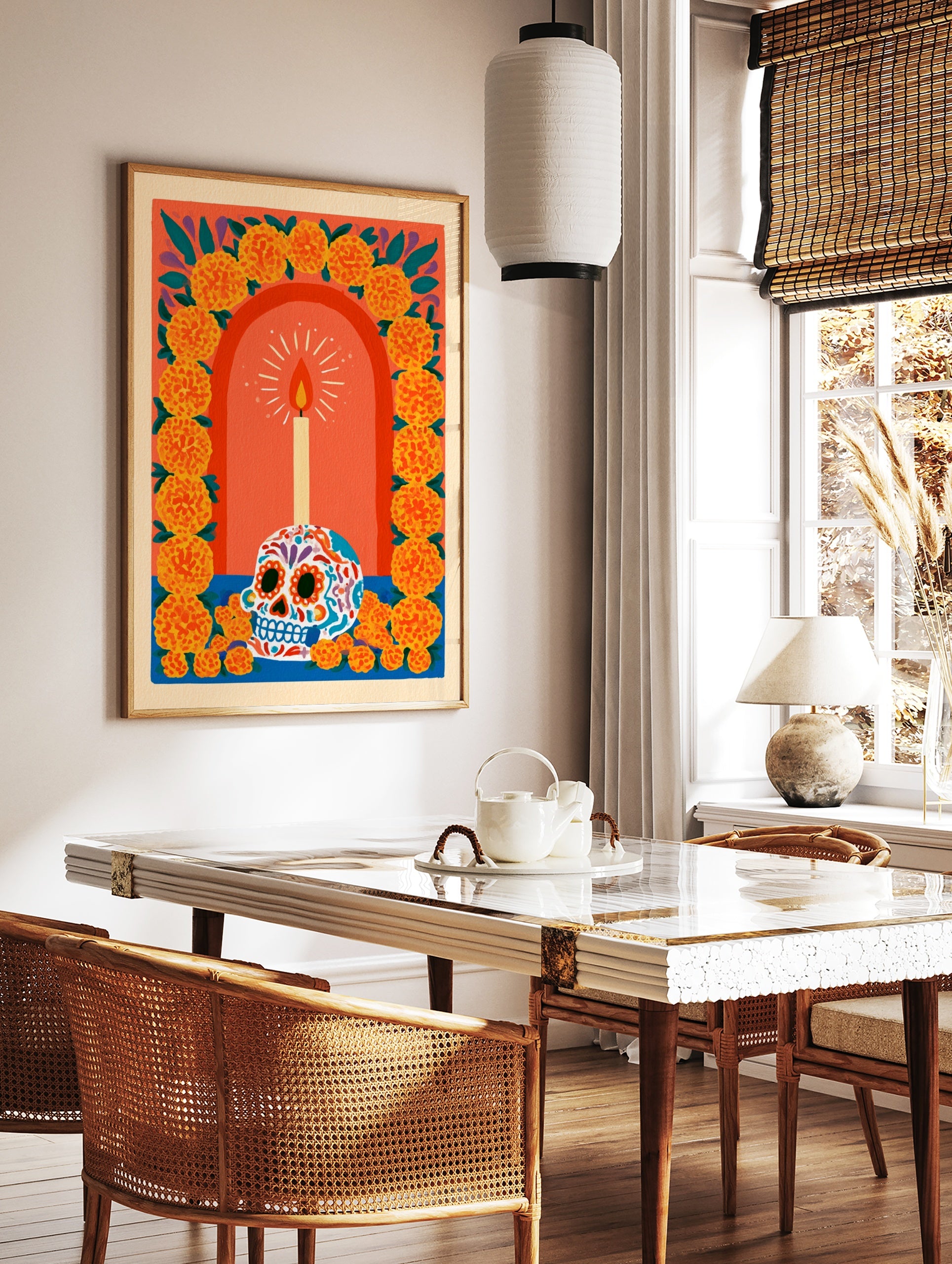 Sugar skull illustration with lit candle and marigold flower arch on orange background, vibrant, in a styled room mockup