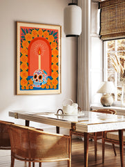 Sugar skull illustration with lit candle and marigold flower arch on orange background, vibrant, in a styled room mockup