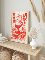 Illustration of a fat cat as a sumo wrestler on a cushion surrounded by koi fish, red and, in an alternate framed mockup