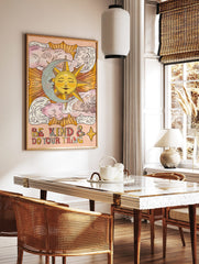 Celestial sun and moon wall art with 'Be Kind & Do Your Thing' text and clouds on a peach background, displayed as the same artwork in a styled poster mockup for home decor