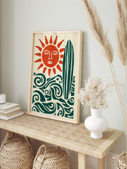 Illustrative sun with face, surfboard, and ocean waves in deep teal and burnt orange on cream, in an alternate framed mockup
