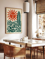 Illustrative sun with face, surfboard, and ocean waves in deep teal and burnt orange on cream, in a styled room mockup