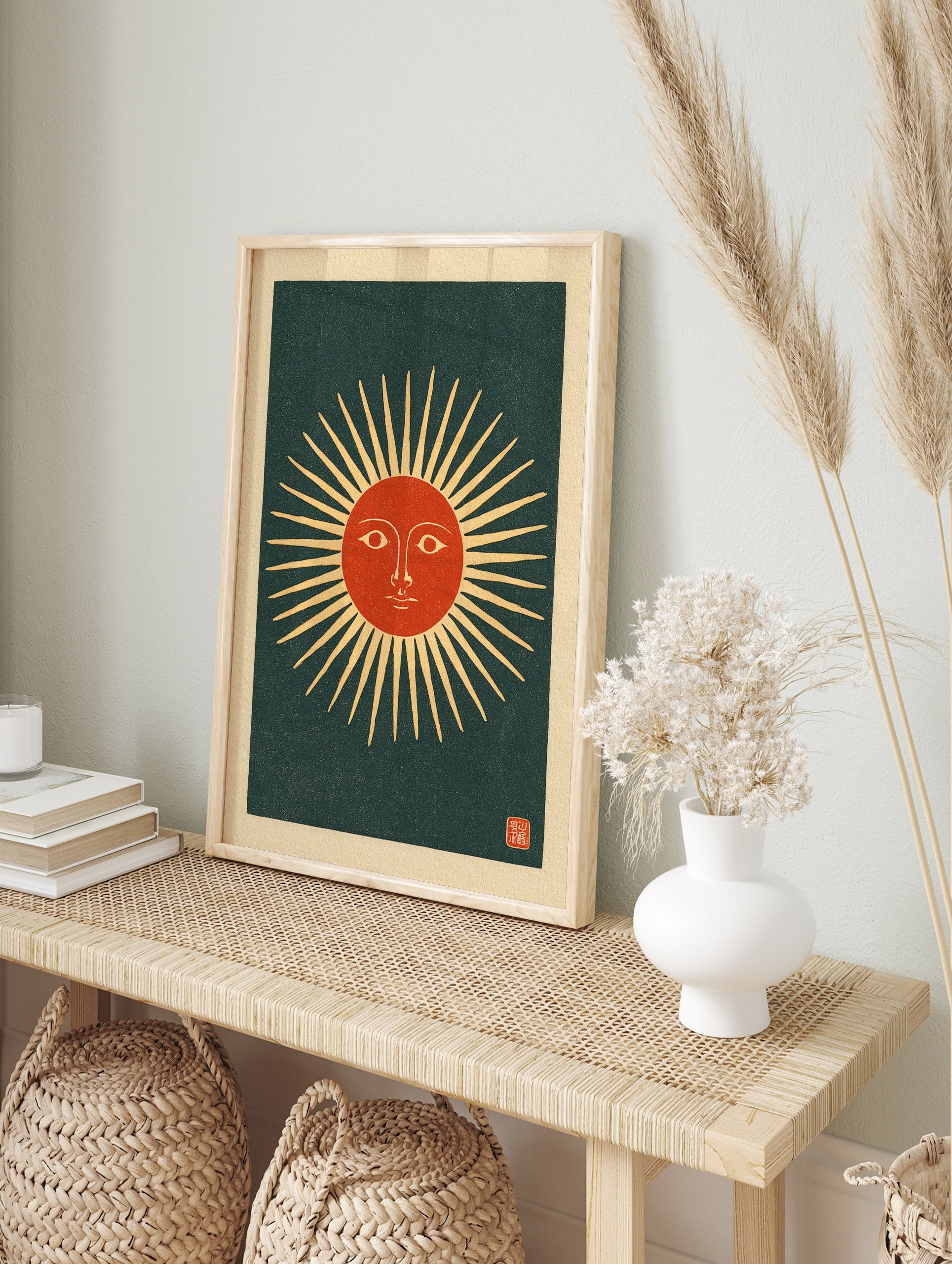 Stylised sun face with radiating beams and a red centre on a dark background, in a vintage, in an alternate framed mockup