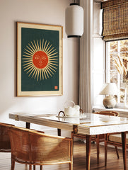 Stylised sun face with radiating beams and a red centre on a dark background, in a vintage, in a styled room mockup