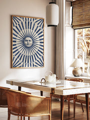 Classical sun face illustration with blue and beige radiating stripes art print, in a styled room mockup