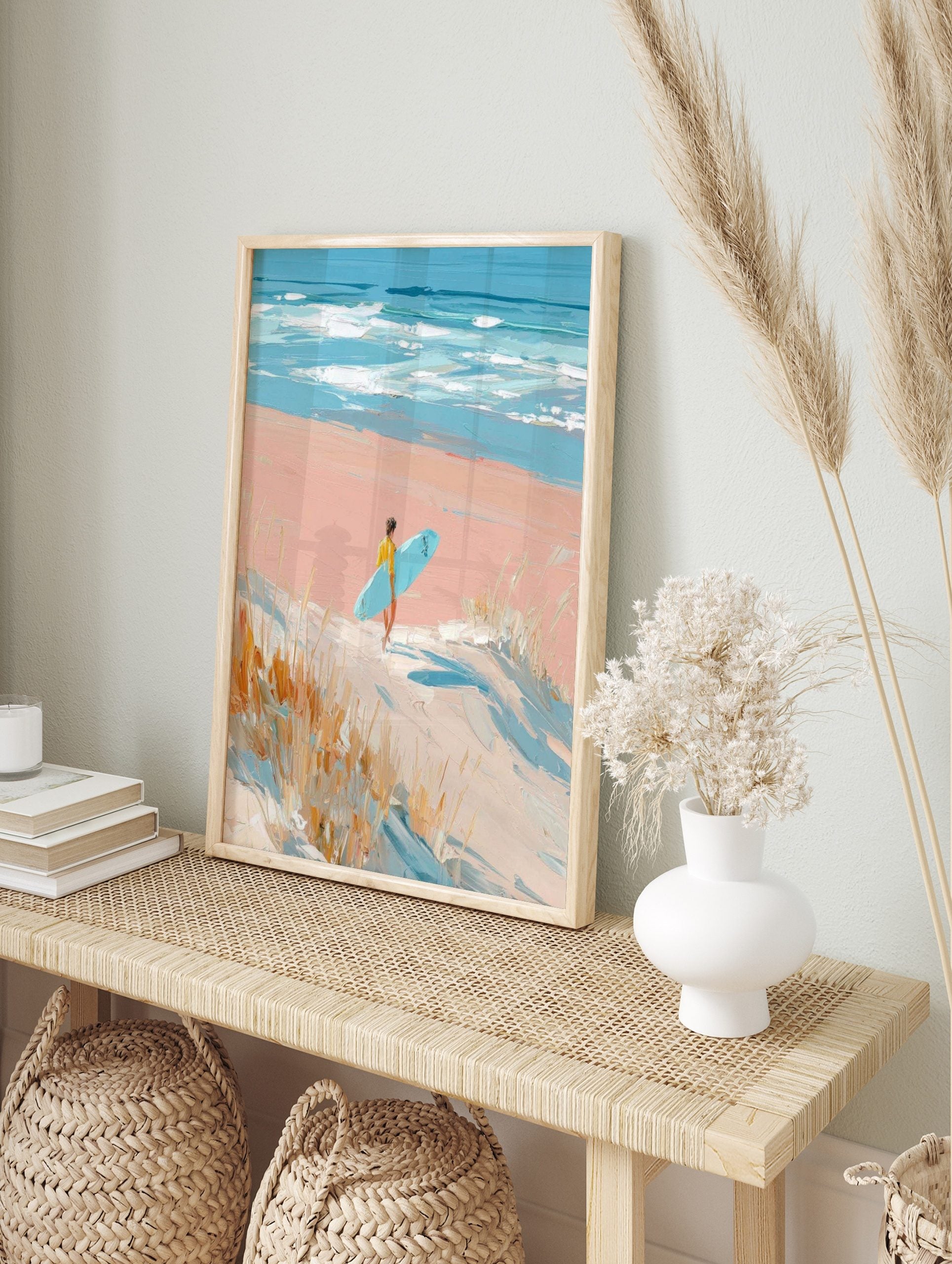 Impressionistic painting of surfer with blue board walking on pink beach towards ocean waves, in an alternate framed mockup