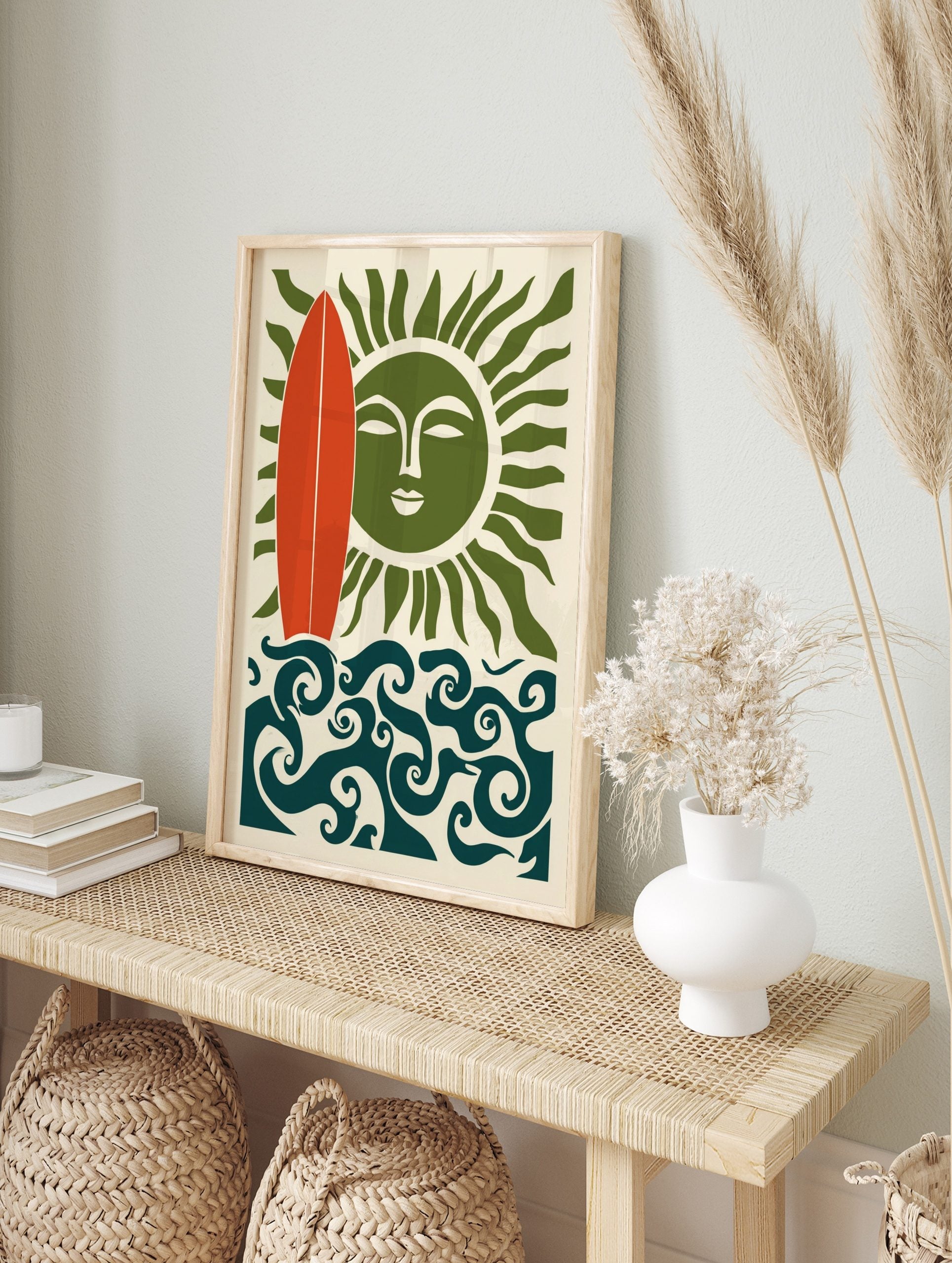 Illustrative wall art with red surfboard, green sun with face, and swirling blue ocean waves, in an alternate framed mockup