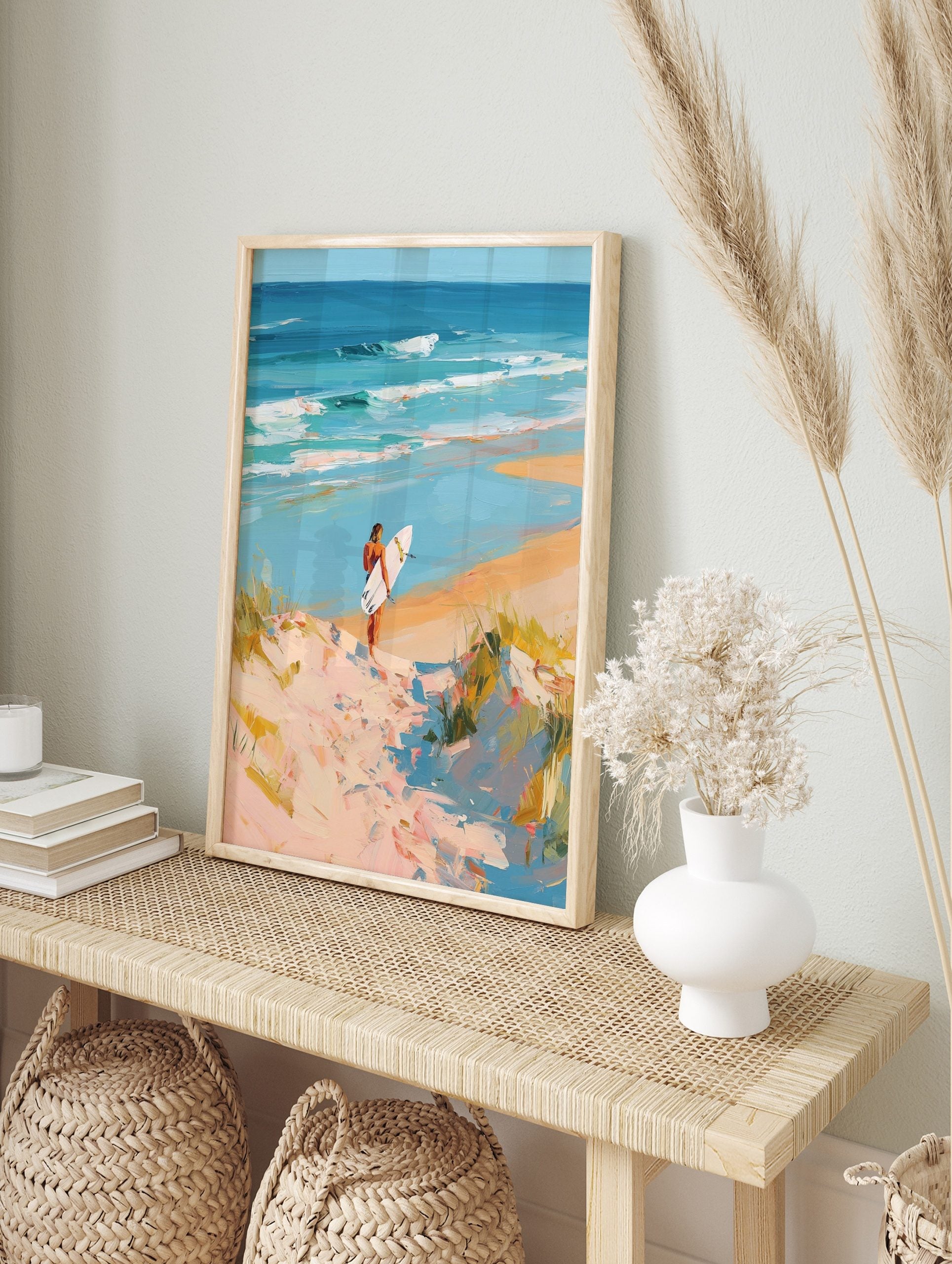 Impressionist painting of surfer on sandy dune path overlooking turquoise ocean waves and, in an alternate framed mockup