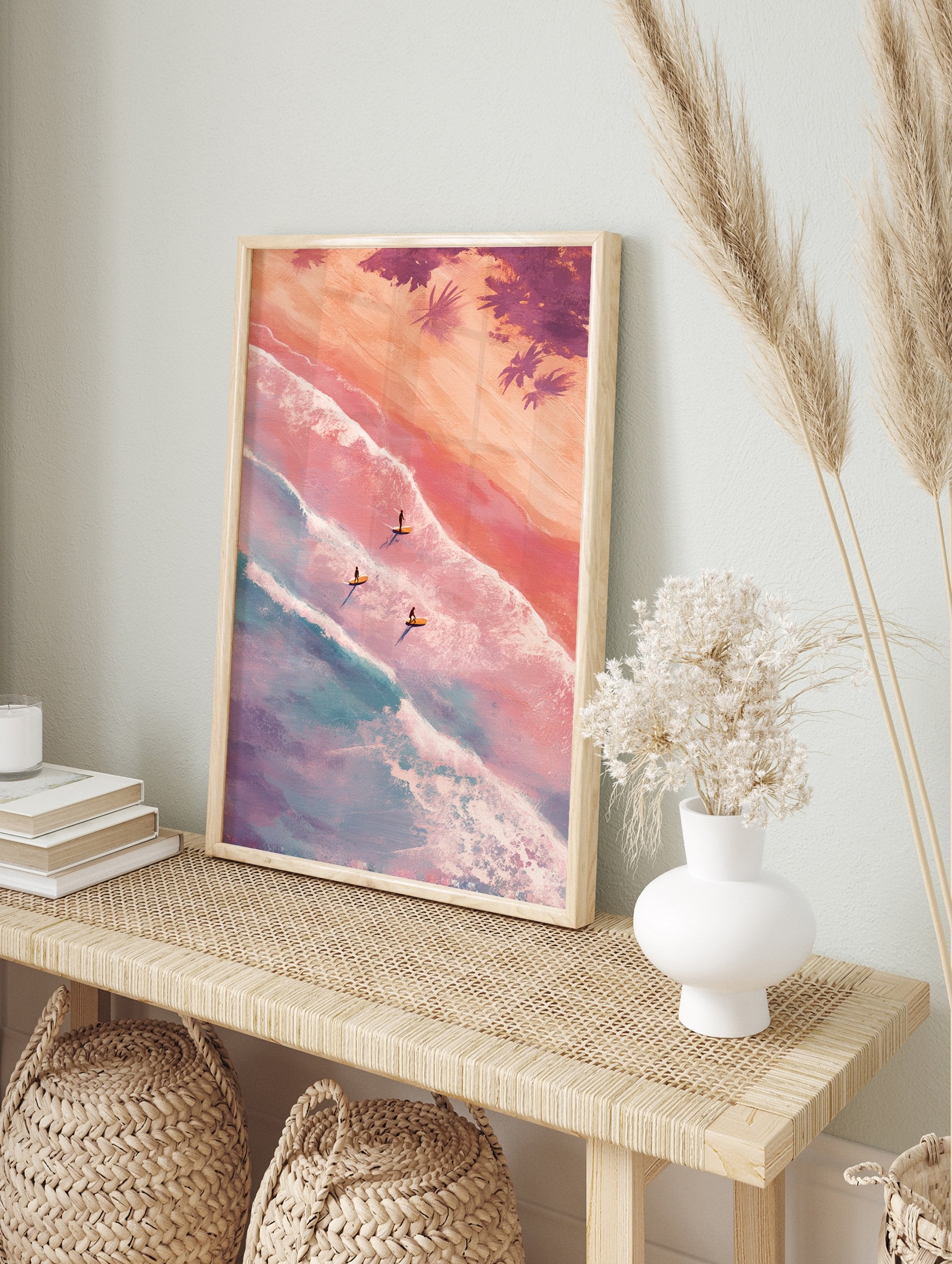 Aerial view poster of three surfers on surfboards in pastel pink and blue ocean waves with sandy beach and palm trees. - Image 4