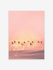 Pink sunset surfing poster with multiple surfers silhouetted on shimmering water, creating a serene beach scene.