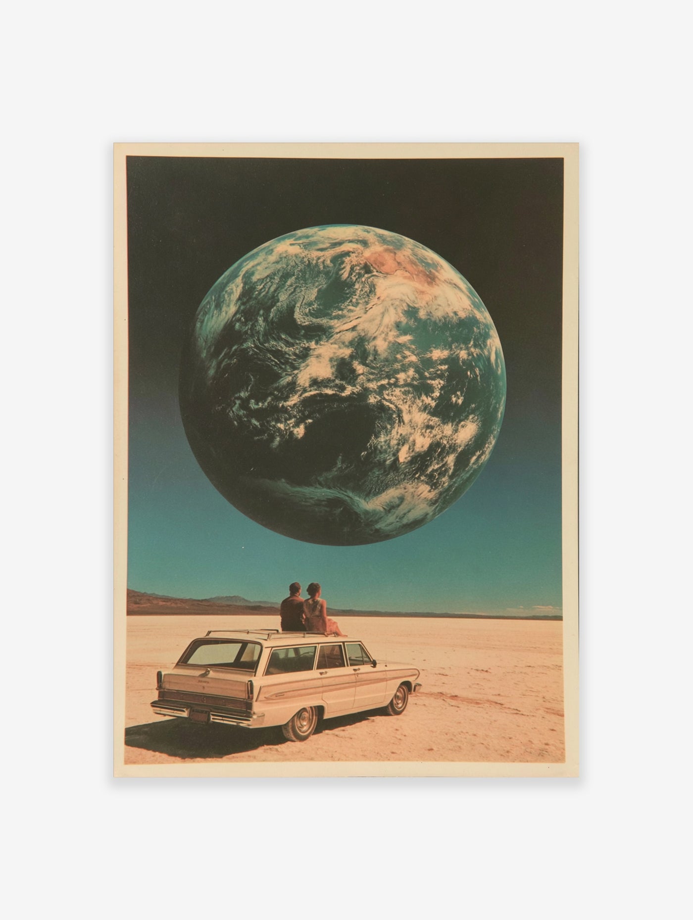 Surreal art print of a couple on a vintage car roof looking at a giant Earth in a desert landscape