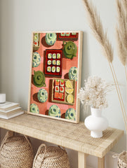 Overhead view of illustrative sushi rolls, salmon sashimi, lemon, green teapots, and, in an alternate framed mockup