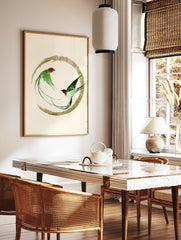 Two green swallow birds in flight inside a golden brushstroke circle, Japanese inspired art print, in a styled room mockup