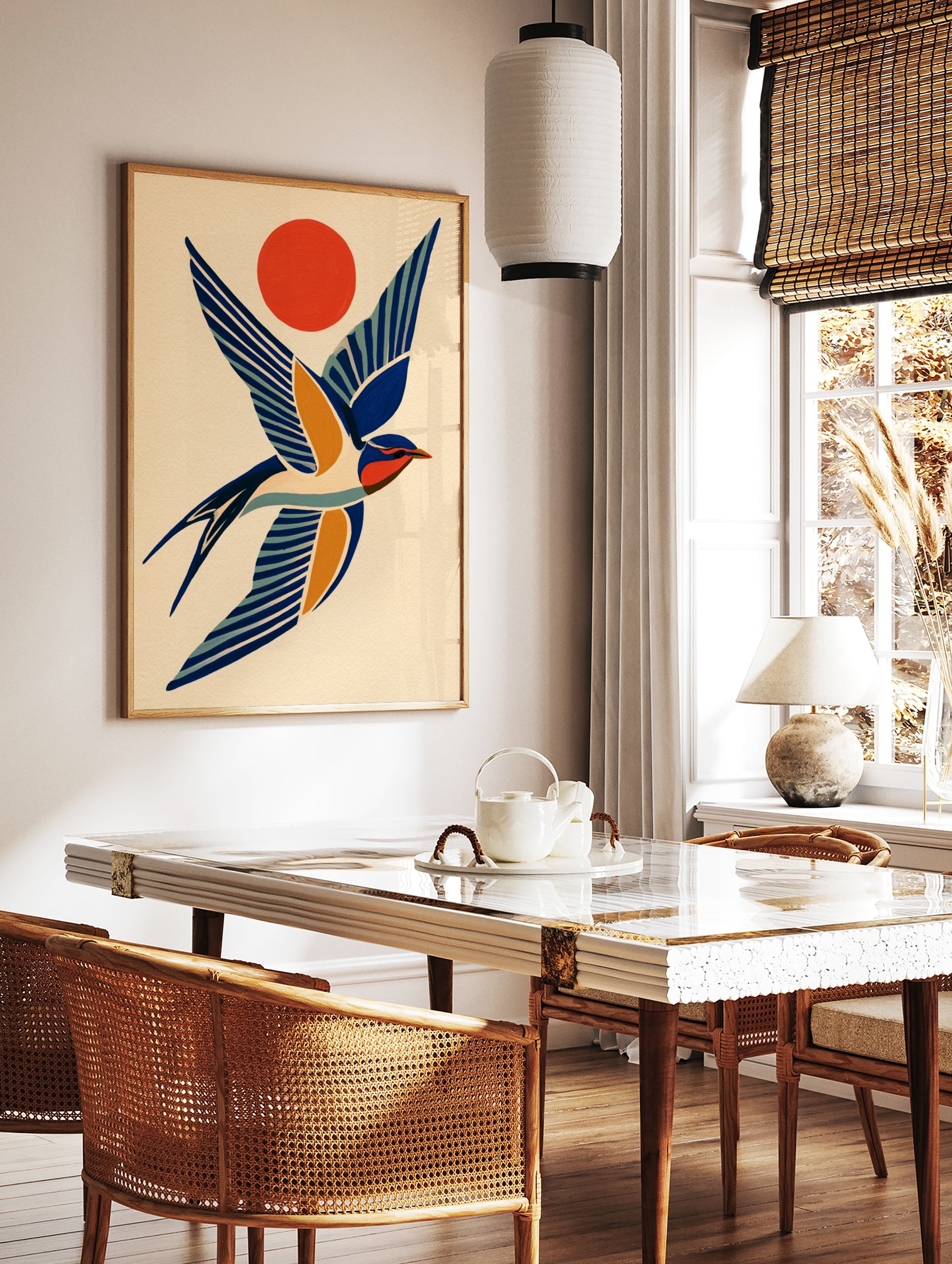 Stylised swallow bird illustration in blue and orange with a sun motif on a cream background, in a styled room mockup