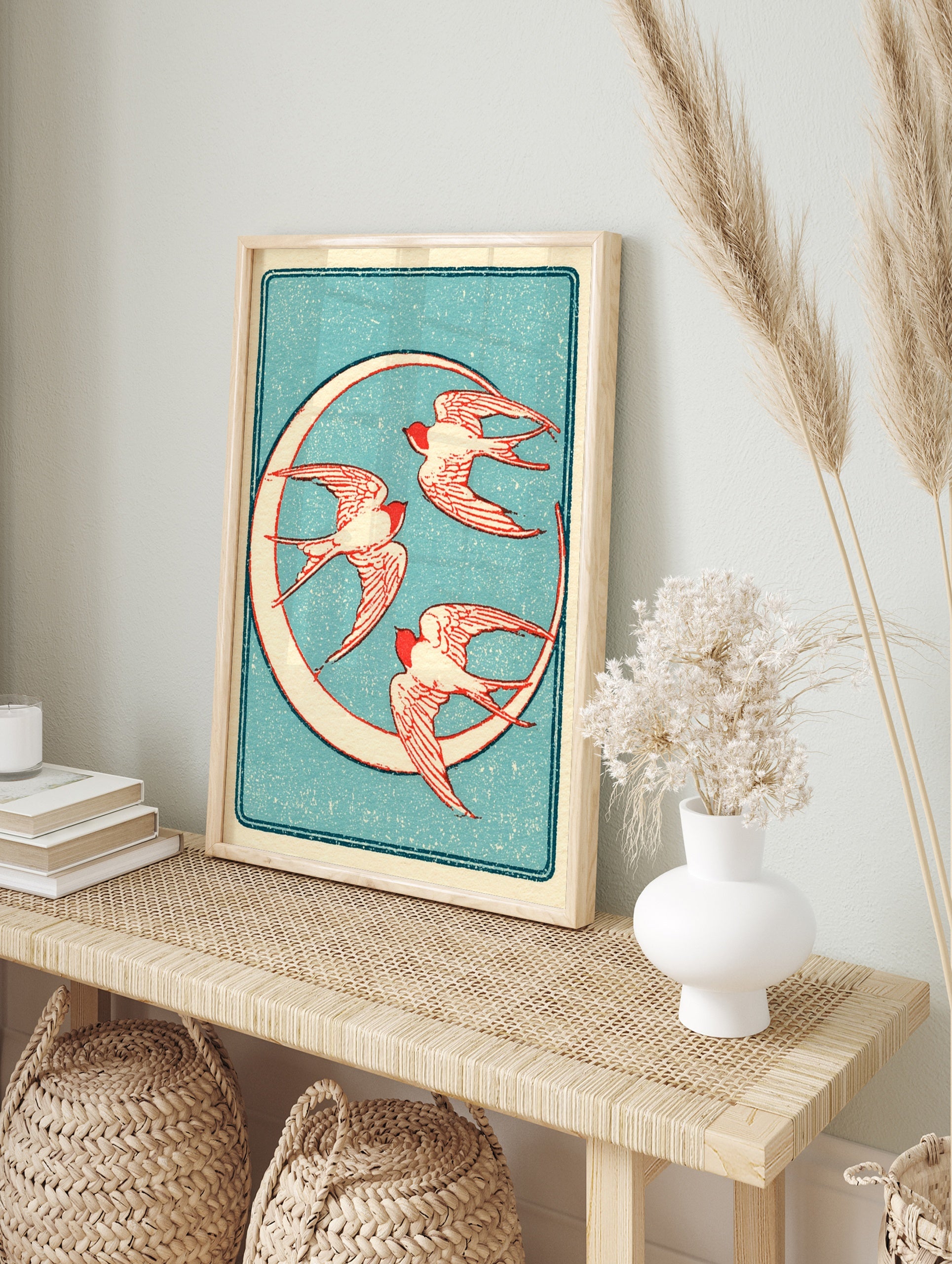 Vintage style illustration of three red swallow birds flying in a circle against a textured, in an alternate framed mockup