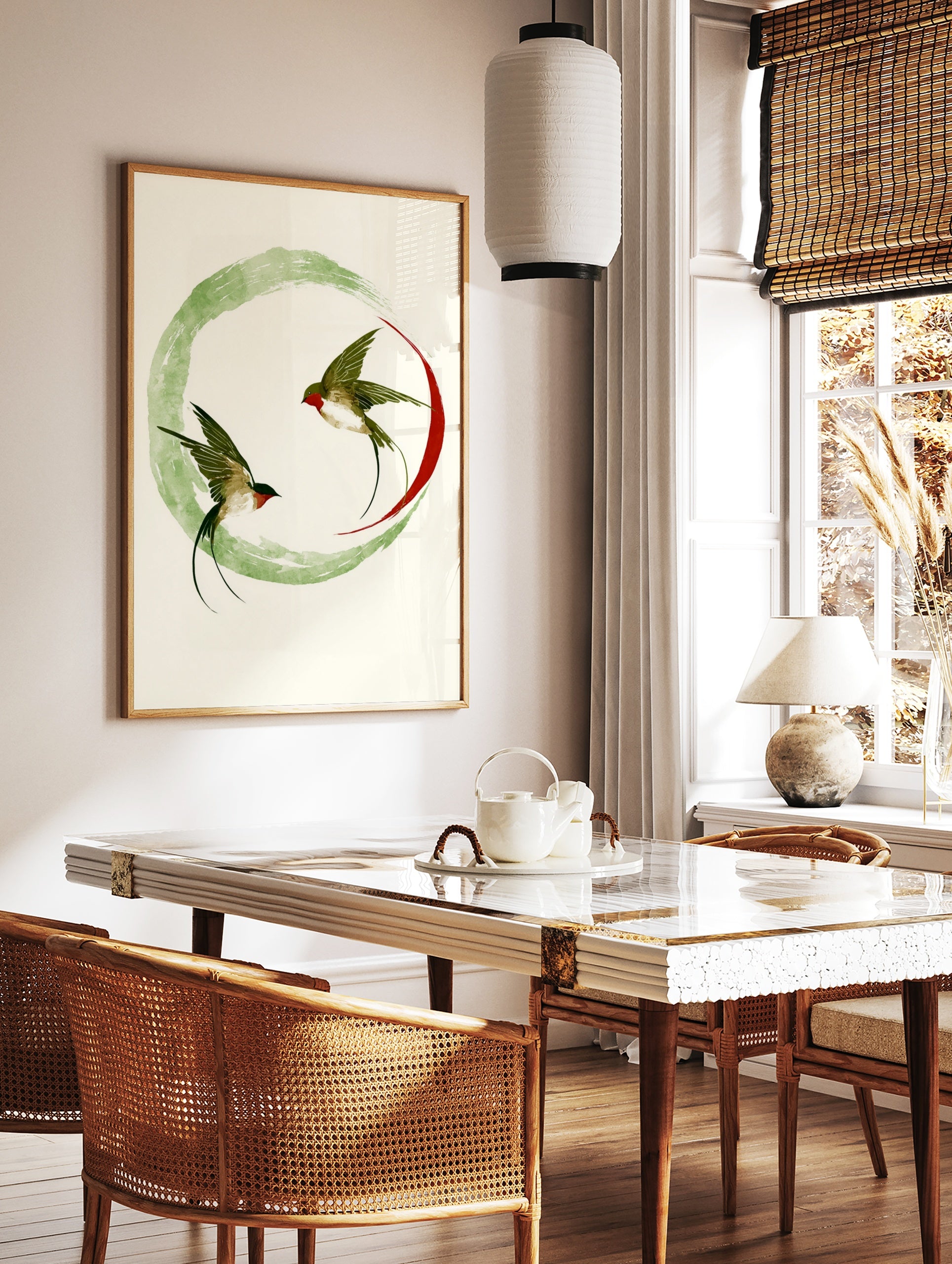 Swallow wall art print with two birds in flight inside a green ink wash circle and red arc on, in a styled room mockup