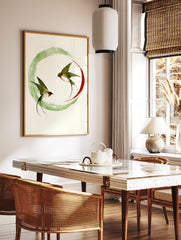Swallow wall art print with two birds in flight inside a green ink wash circle and red arc on, in a styled room mockup