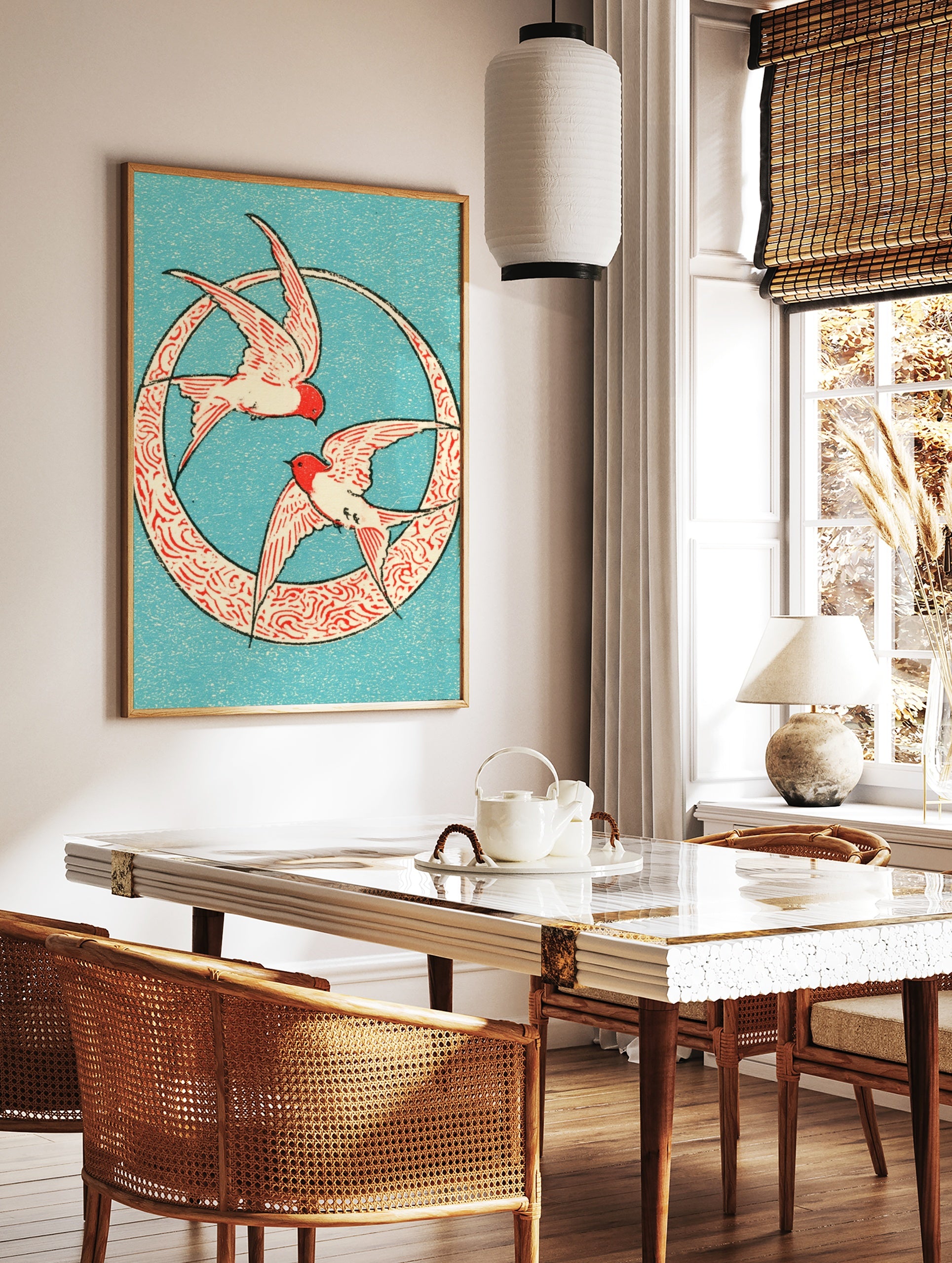 Two swallows in red and cream flying inside a circular patterned frame on a blue background, in a styled room mockup