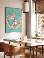 Two swallows in red and cream flying inside a circular patterned frame on a blue background, in a styled room mockup