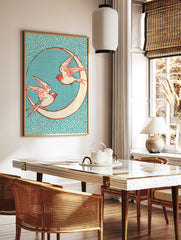 Vintage-style illustrative print of two swallows flying around a crescent moon against a speckled, in a styled room mockup