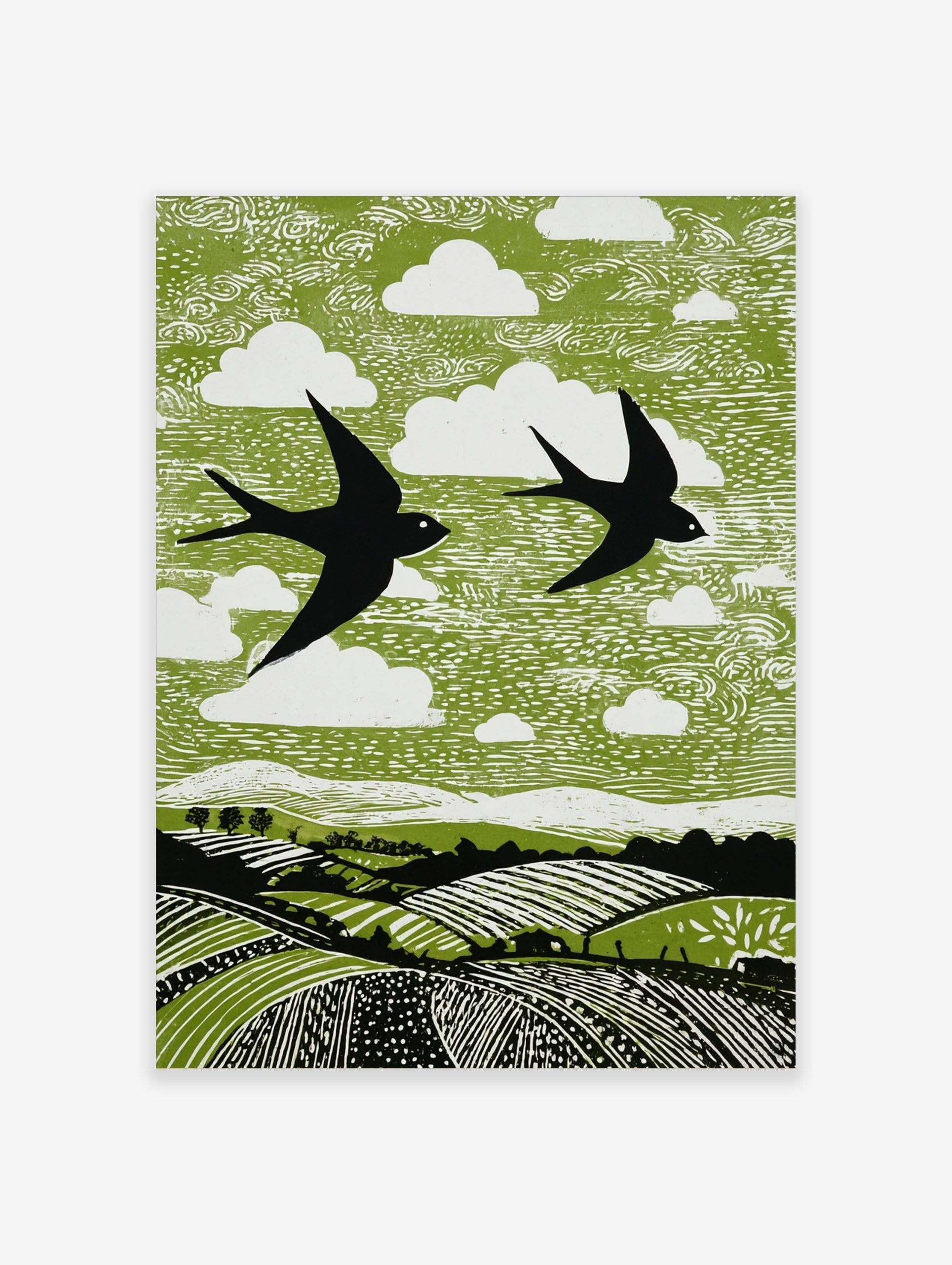 Linocut style print of two black swallows flying over green fields with white clouds