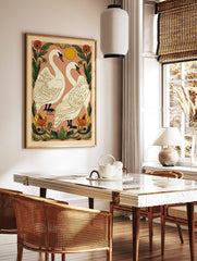 Illustrative art print of two white swans facing each other, surrounded by red and yellow flowers, in a styled room mockup