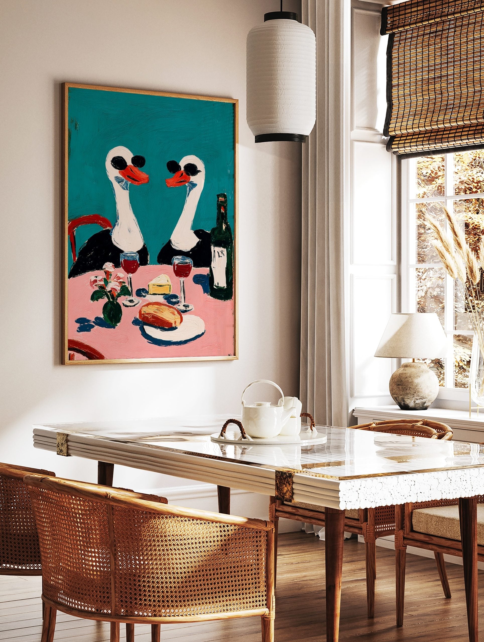 Painterly wall art of two swans in sunglasses at a pink dining table with wine, cheese, and flowers, in a styled room mockup