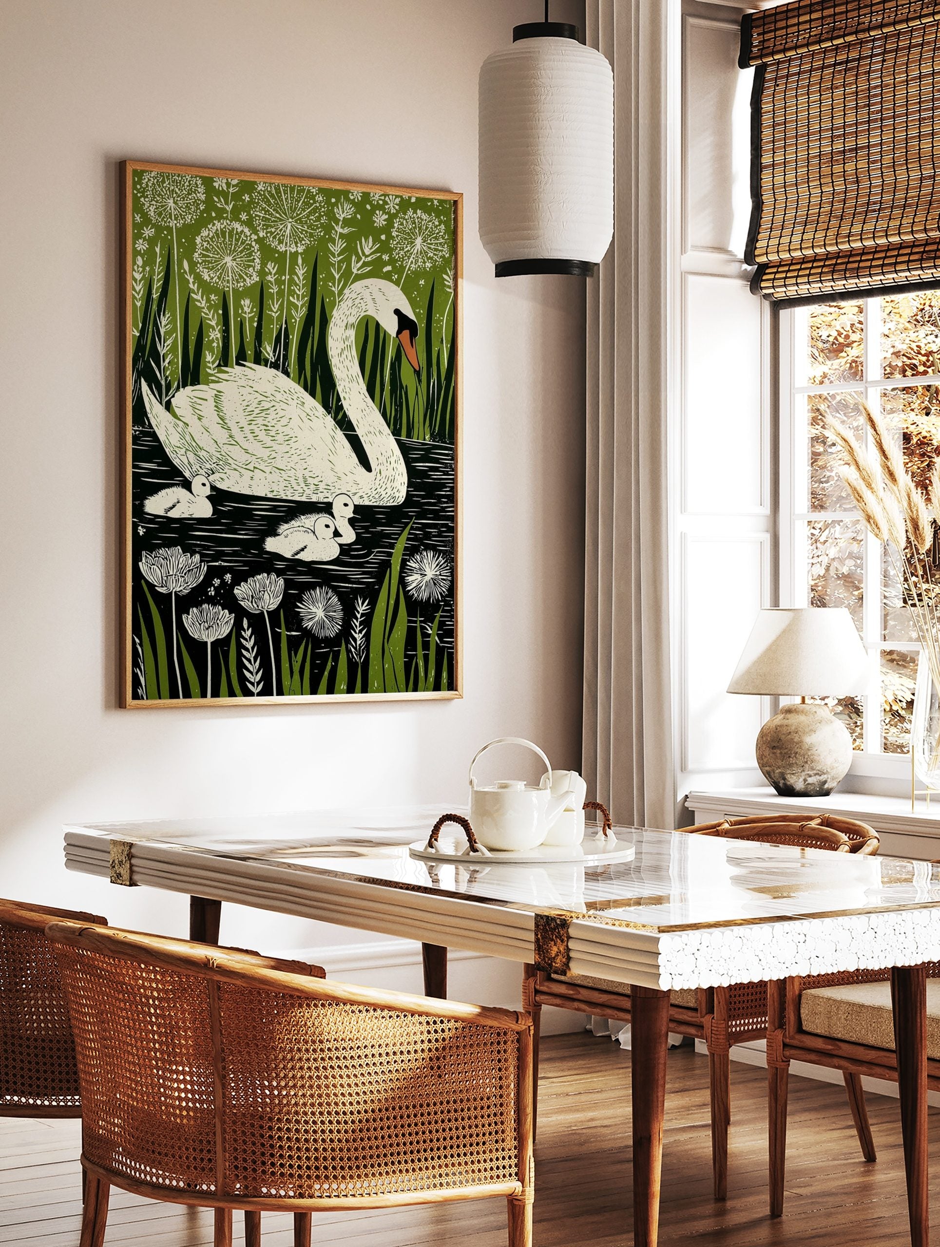 Illustrative print of a white mother swan and three cygnets in dark water, surrounded by green, in a styled room mockup