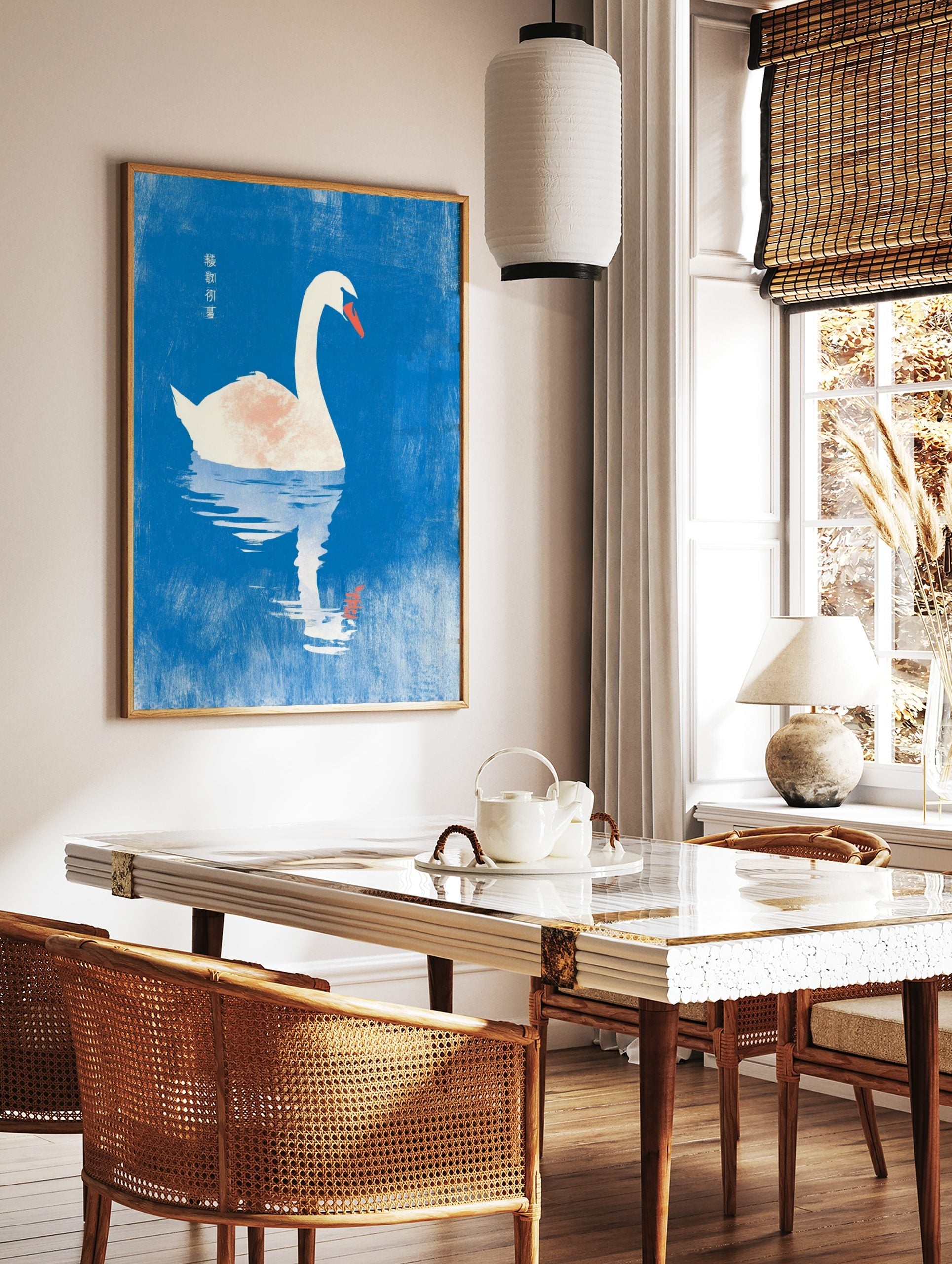 White swan with orange beak floating on blue water with reflection and Chinese text, in a styled room mockup