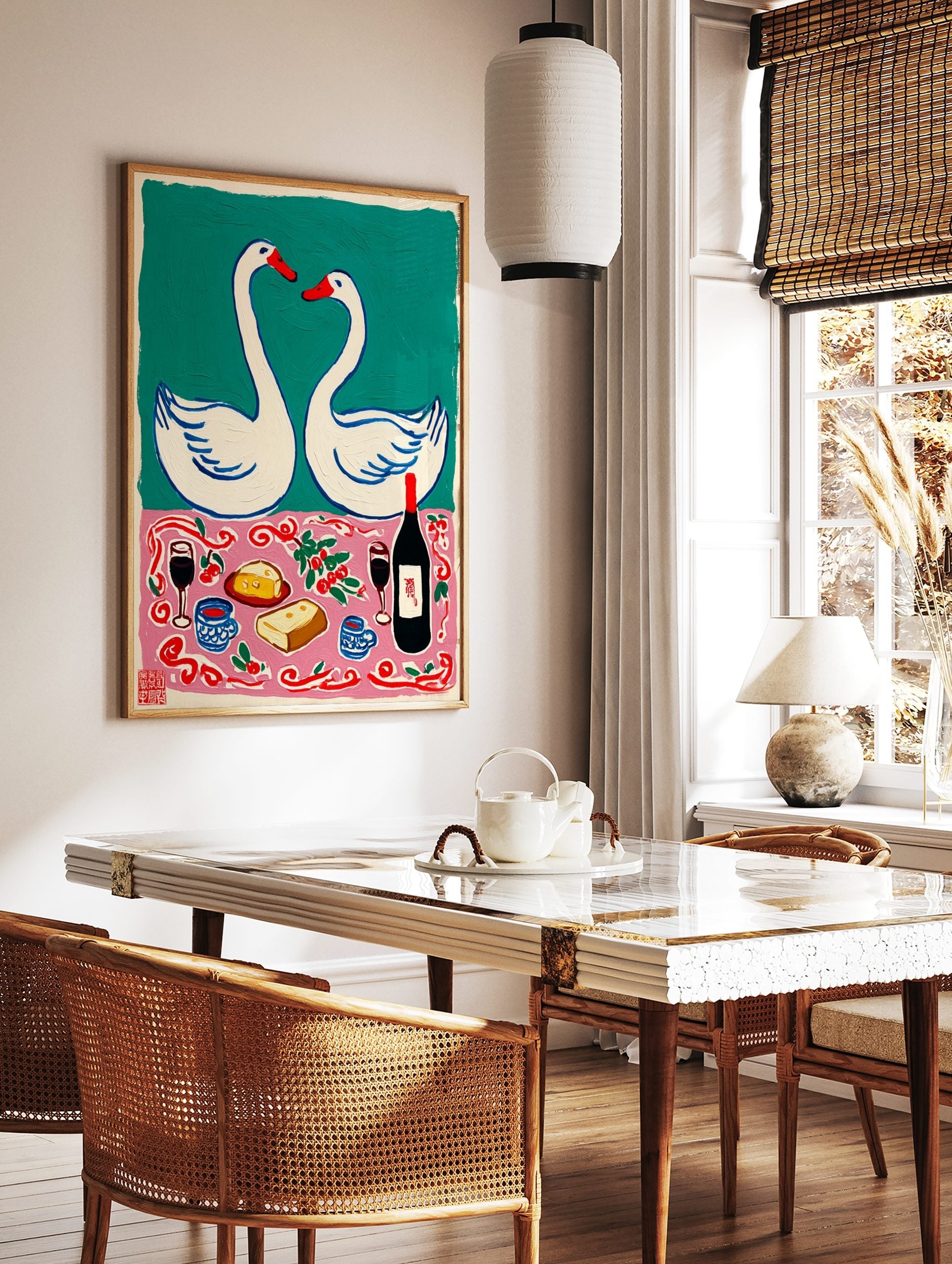 Illustrative wall art with two white swans and a romantic picnic scene with wine, cheese, and bread, in a styled room mockup