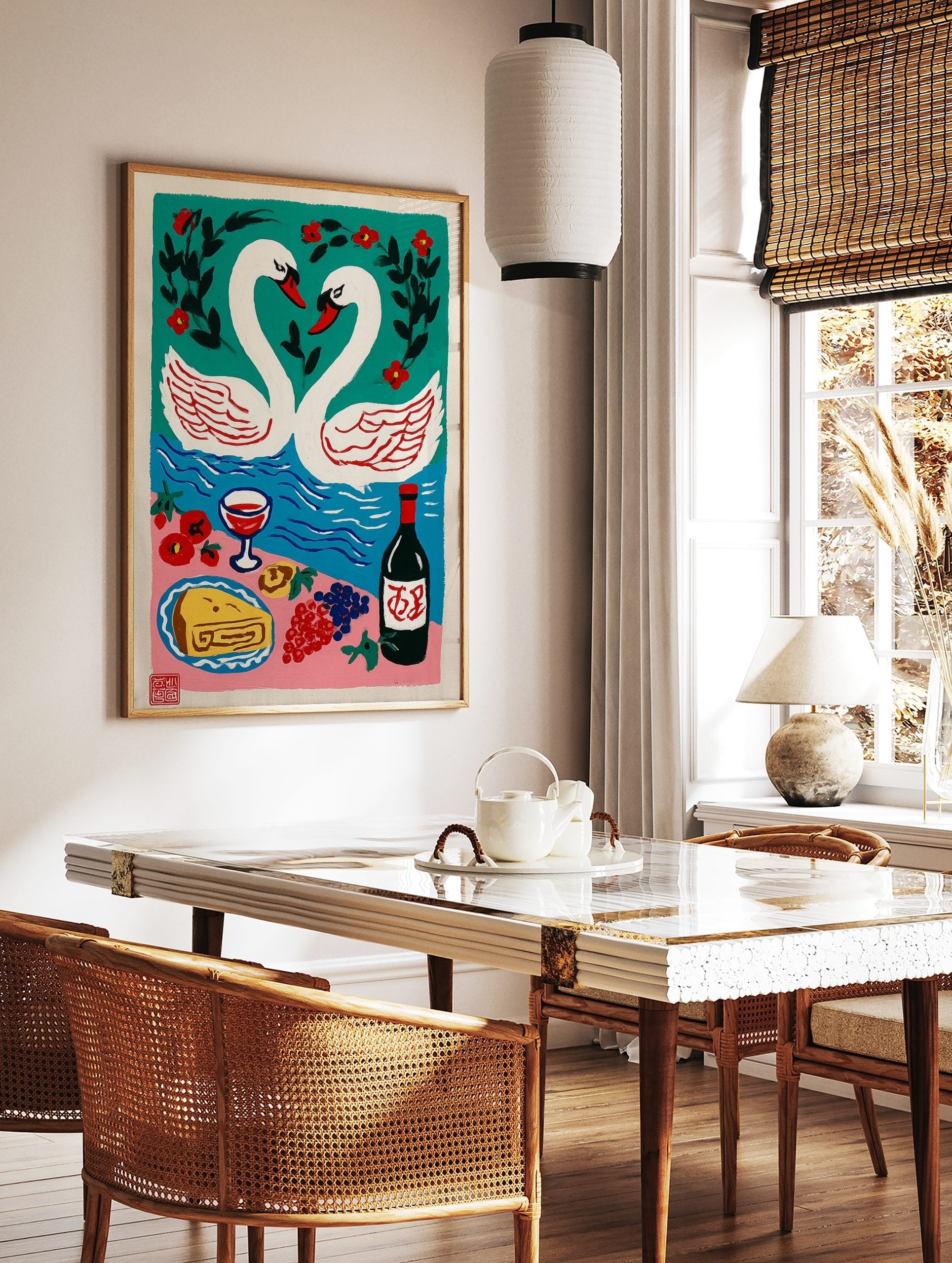 Illustrative art print of two white swans forming a heart, a blue lake, red flowers, and a picnic, in a styled room mockup