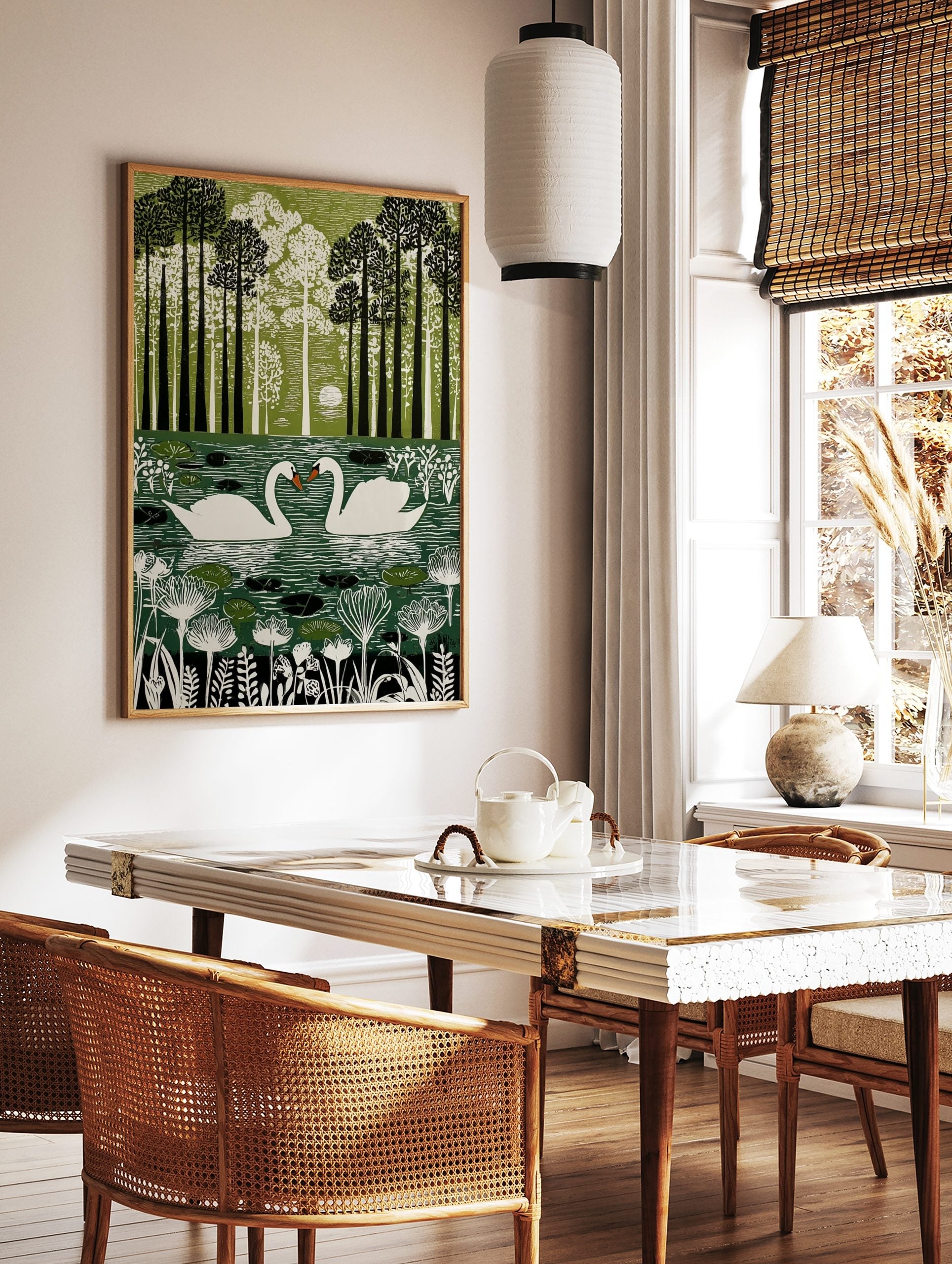 Illustrative green wall art print of two white swans on a pond surrounded by tall trees and foliage, in a styled room mockup