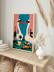 Quirky illustrative art print of two white swans in sunglasses having dinner with wine, in an alternate framed mockup