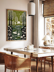 Green and white illustrative print of swans on a pond in a forest with birds flying overhead and sun, in a styled room mockup