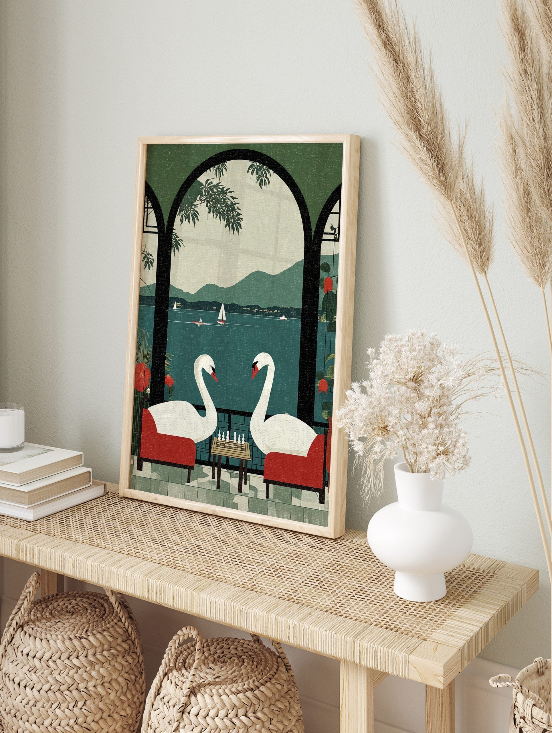 Illustrative print of two white swans playing chess in red chairs on a balcony overlooking a, in an alternate framed mockup