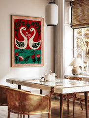 Illustrative wall art of two white swans with wine glasses, forming a heart, against a red and, in a styled room mockup